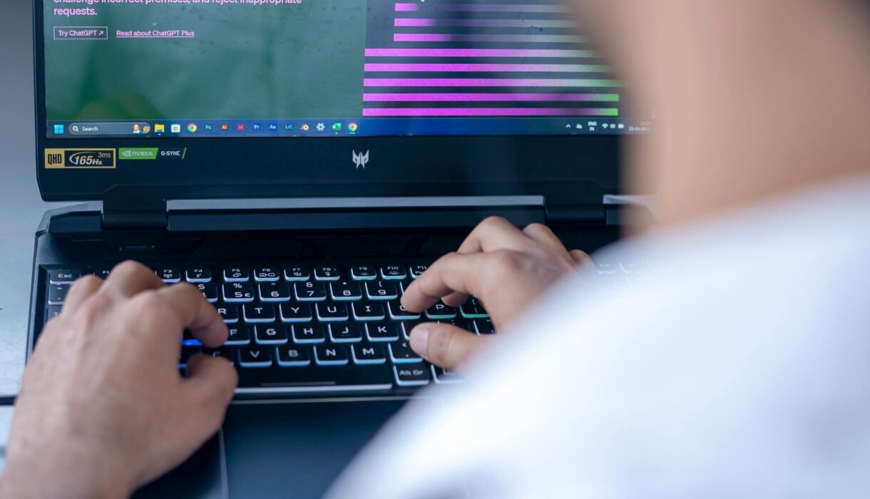 Focused shot of a man using ChatGPT on laptop. Ideal for tech-related content.